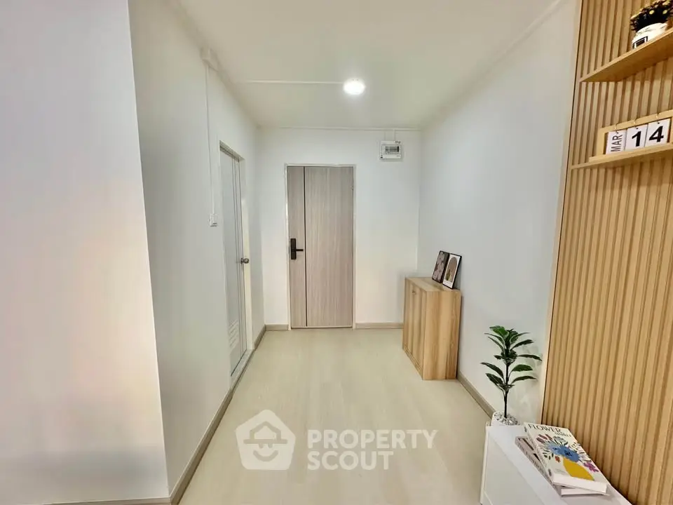 Modern hallway with sleek wooden accents and minimalist decor
