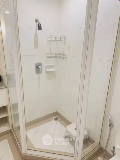 Modern bathroom with glass shower enclosure and sleek fixtures