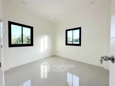 Bright empty room with large windows and glossy floor tiles, perfect for customization.