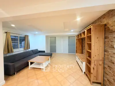 Spacious living room with modern furniture and stylish wooden shelving