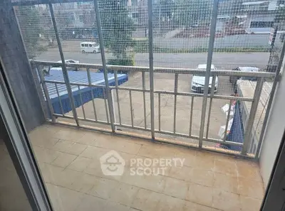 Spacious balcony with street view, perfect for relaxation and outdoor enjoyment.