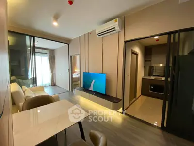 Modern living room with open kitchen and stylish decor in a contemporary apartment.