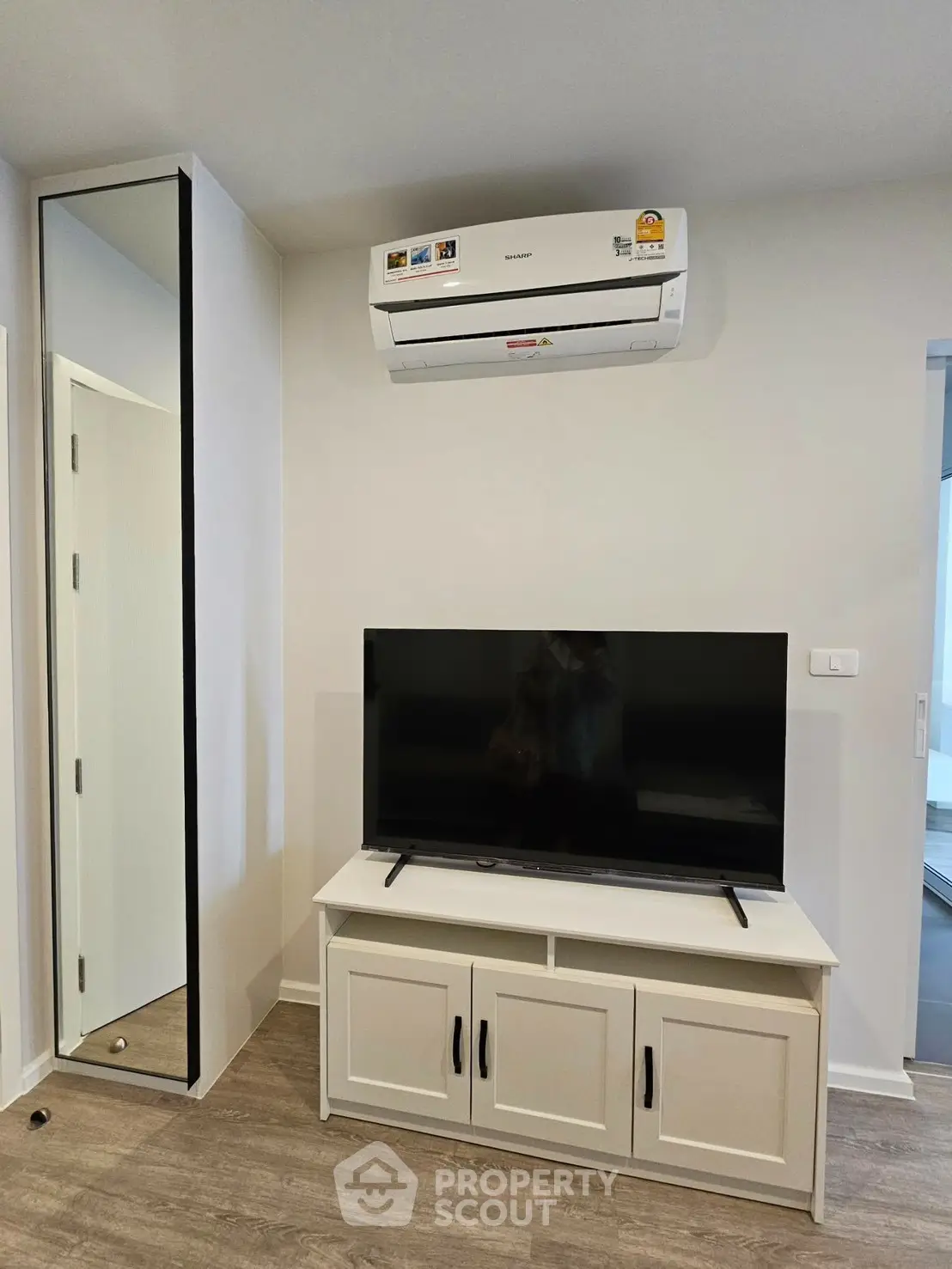 Modern living room with air conditioning and sleek TV setup