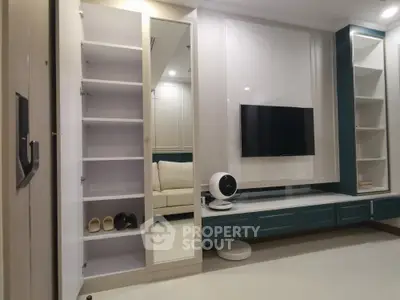 Modern living room with sleek TV setup and stylish shelving