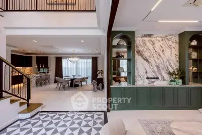 Luxurious open-plan living room with elegant marble accents and modern dining area
