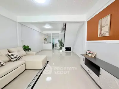 Spacious modern living room with elegant decor and comfortable seating in a stylish home.