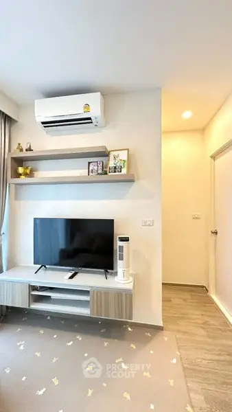 Modern living room with wall-mounted TV and air conditioning unit