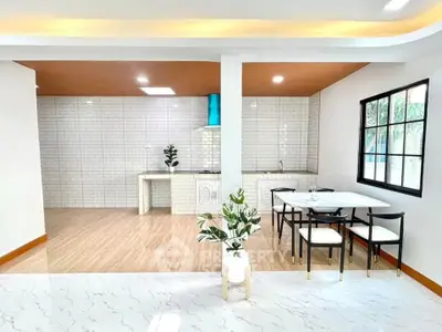 Modern open-layout kitchen with dining area and stylish decor