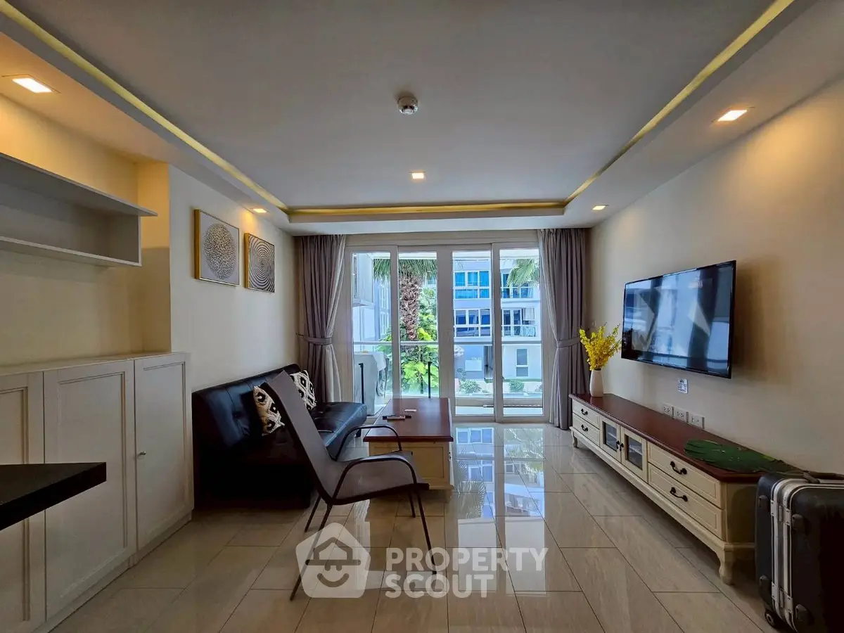 Modern living room with sleek furniture and large windows offering natural light.