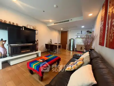 Stylish living room with modern decor and open layout, featuring a cozy seating area and dining space.