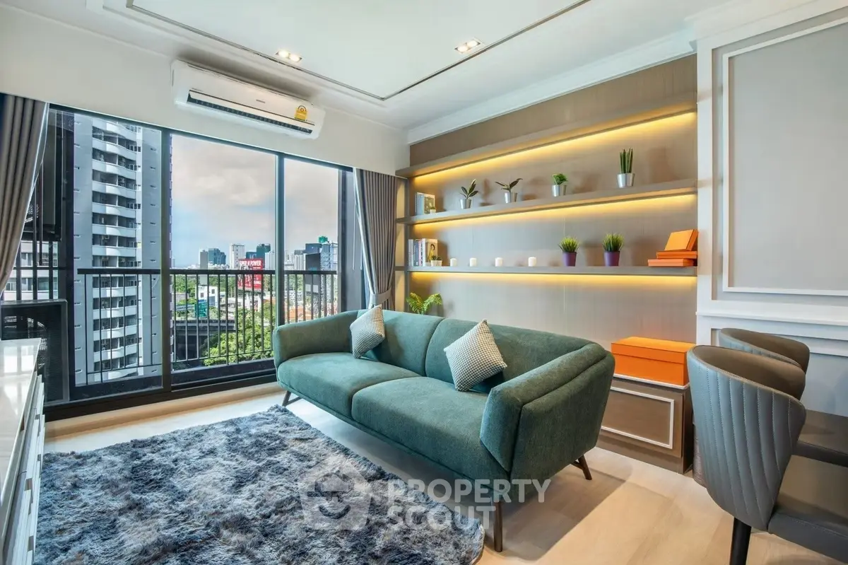 Modern living room with city view, stylish sofa, and decorative shelves.