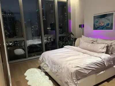 Luxurious bedroom with city view and modern decor, featuring floor-to-ceiling windows and ambient lighting.