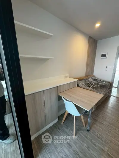 Modern living room with sleek furniture and wooden flooring, perfect for urban living.