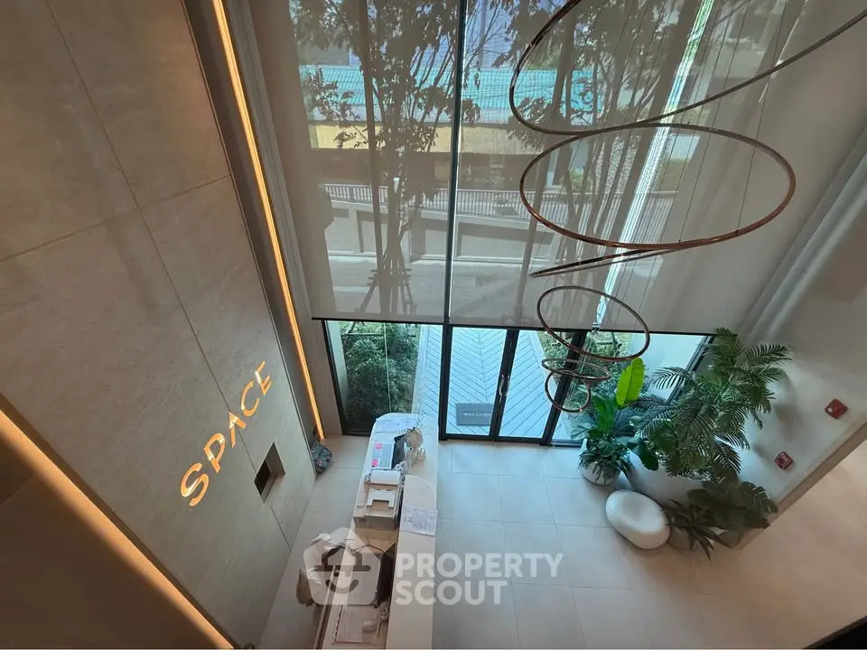 Modern building entrance with high ceilings and stylish decor