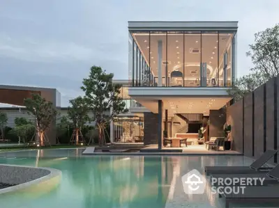 Luxurious modern home with stunning glass architecture and poolside view