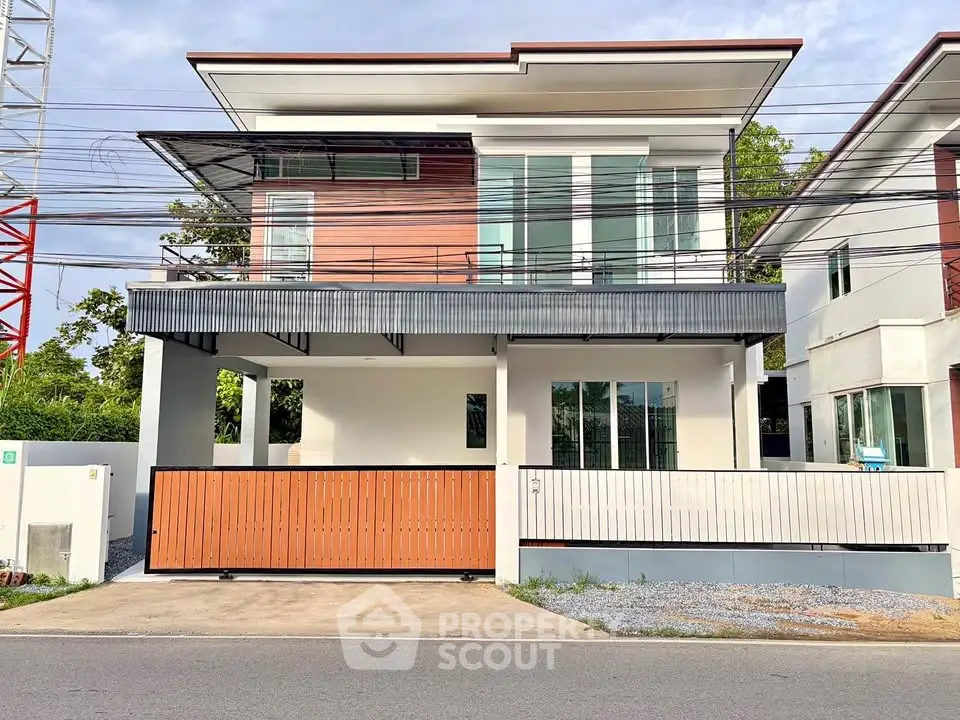 Modern two-story house with sleek design and spacious balcony, perfect for contemporary living.