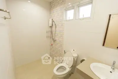 Modern bathroom with tiled walls and compact design