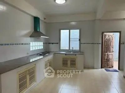Spacious kitchen with modern gas stove and ample counter space