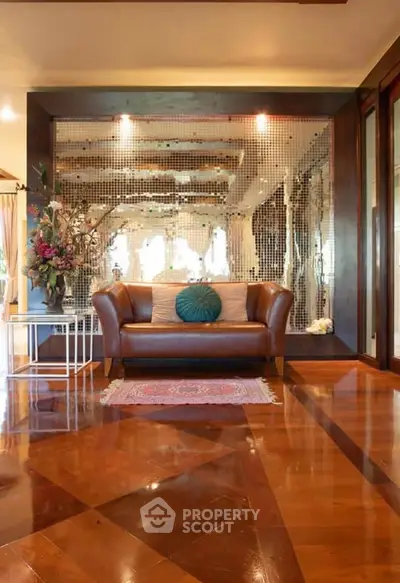 Luxurious living room with elegant leather sofa and mirrored accent wall
