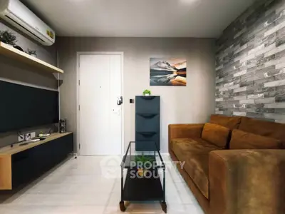 Modern living room with stylish decor, featuring a brown sofa, glass coffee table, and wall-mounted TV unit.