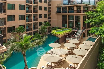 Luxurious apartment complex with stunning pool and lush greenery