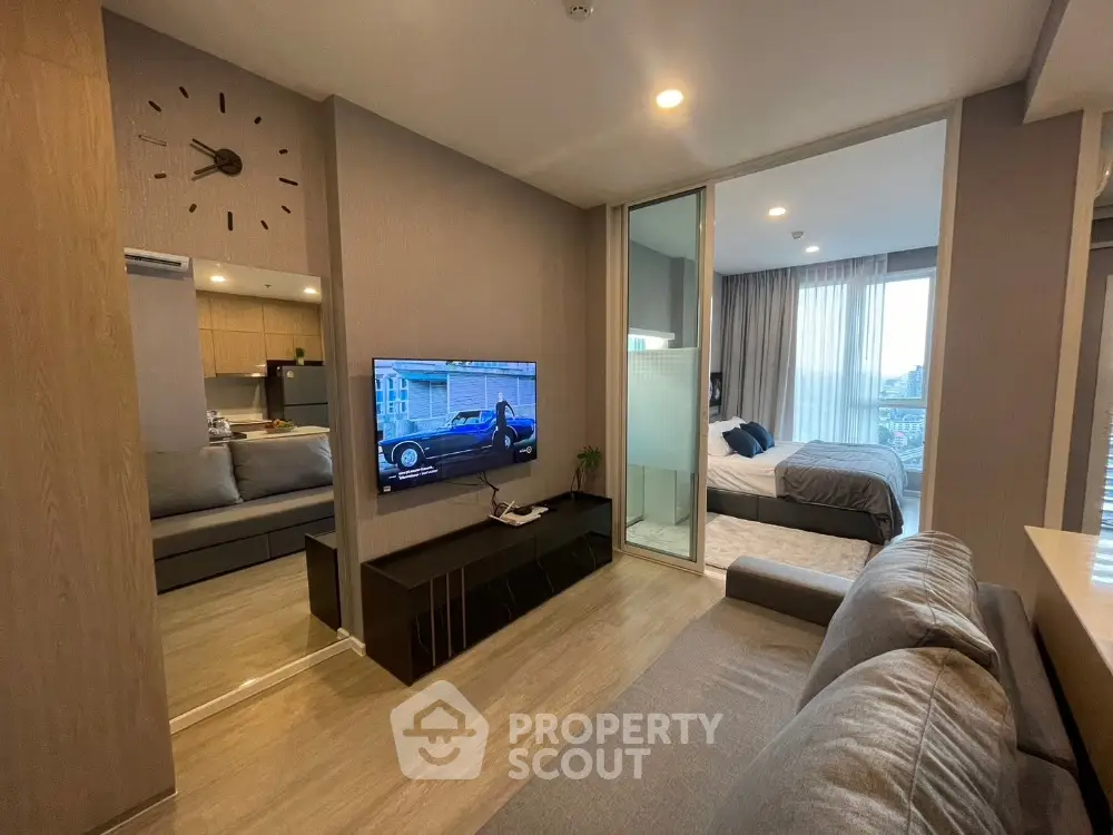 Modern open-plan living room with sleek design and bedroom view