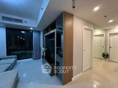 Modern living room with sleek design and large windows offering city views.