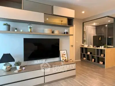 Modern living room with sleek TV unit and stylish decor in a contemporary apartment.