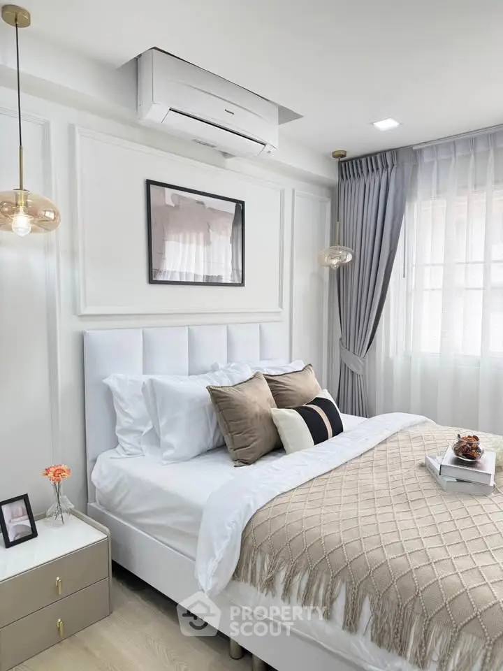 Elegant bedroom with modern decor, cozy bedding, and natural light for a serene atmosphere.