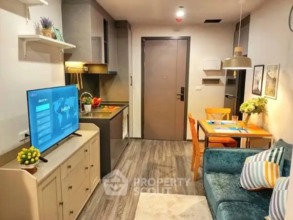 Modern living room with open kitchen, stylish decor, and cozy dining area.