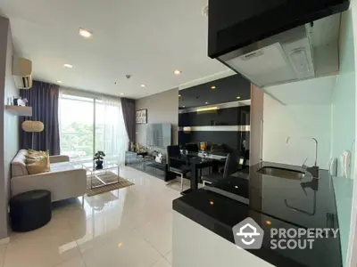 Modern open layout living room with sleek kitchen and balcony view