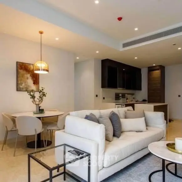 Modern living room with elegant decor and open kitchen layout