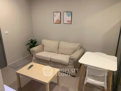 Cozy living room with beige sofa, modern decor, and wooden furniture in a stylish apartment.