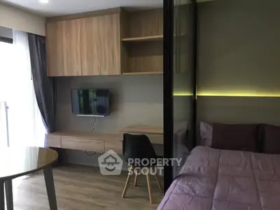 Modern studio apartment with stylish wooden furniture and cozy bed