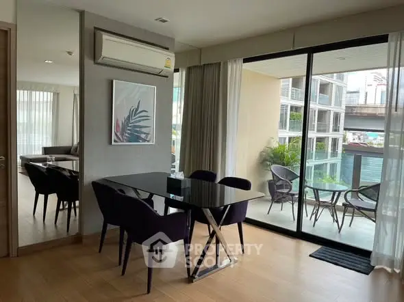 Modern dining area with glass table and balcony view in luxury apartment