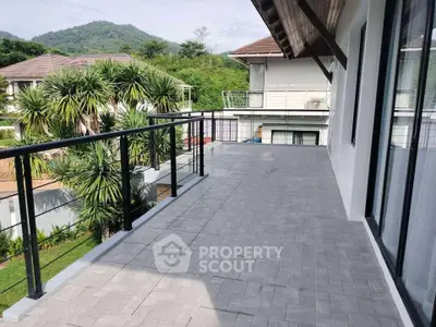 Spacious balcony with scenic mountain views in a modern residential area.