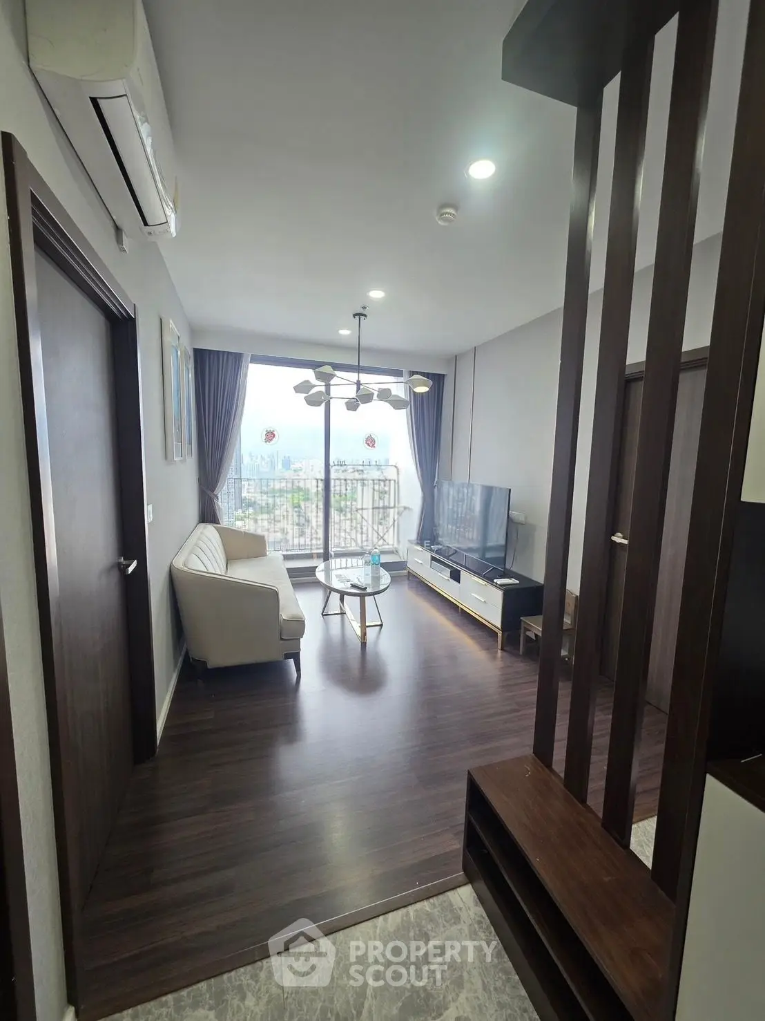 Modern living room with elegant decor and city view balcony