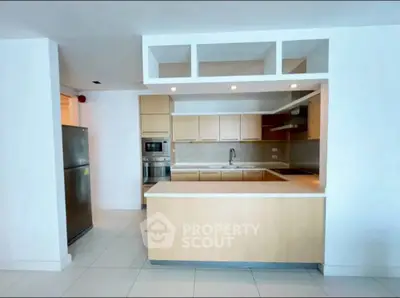 Modern kitchen with sleek cabinetry and stainless steel appliances in open layout.