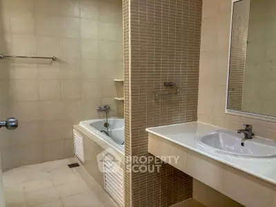 Spacious bathroom with bathtub and modern sink in a stylish apartment.