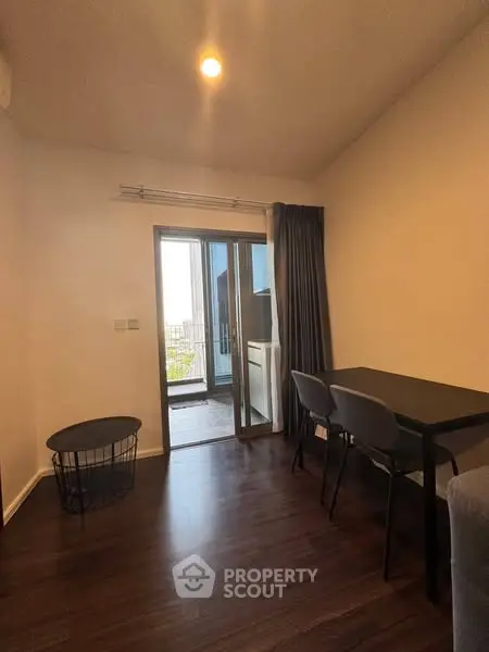 Modern apartment dining area with balcony access and stylish furniture