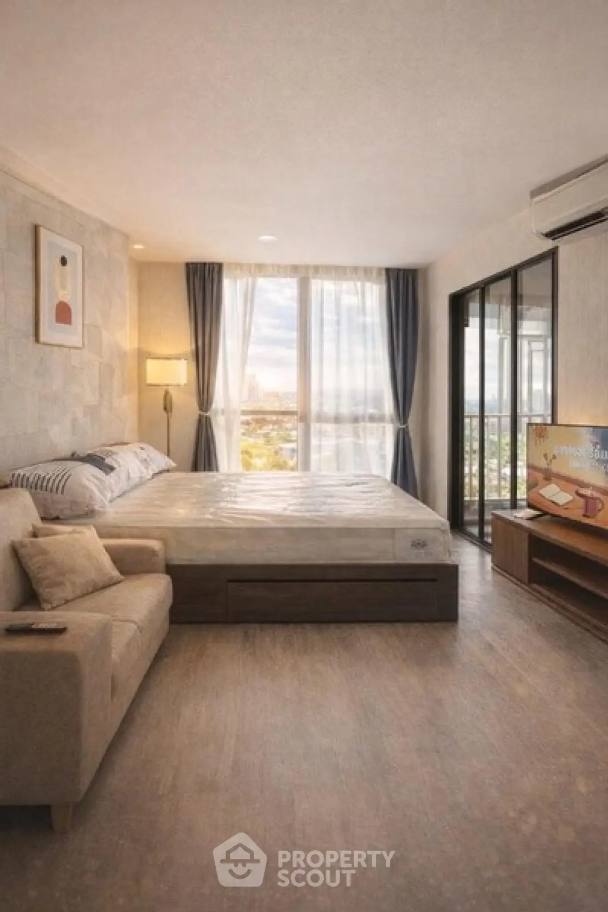 Spacious bedroom with large windows and modern decor, offering a serene and inviting atmosphere.