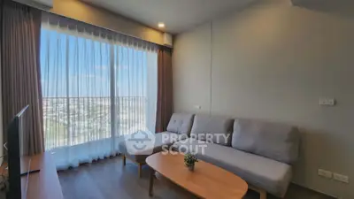 Modern living room with large window and city view, featuring a cozy sofa and stylish decor.