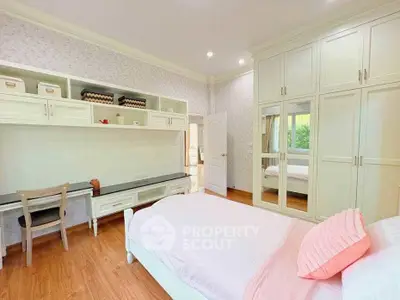 Charming bedroom with built-in storage and cozy decor, perfect for a serene retreat.