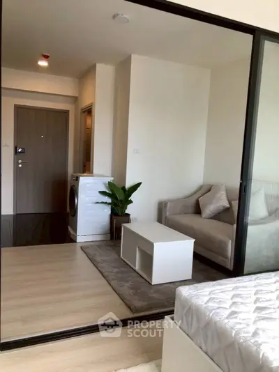 Modern apartment interior with cozy living area and washing machine