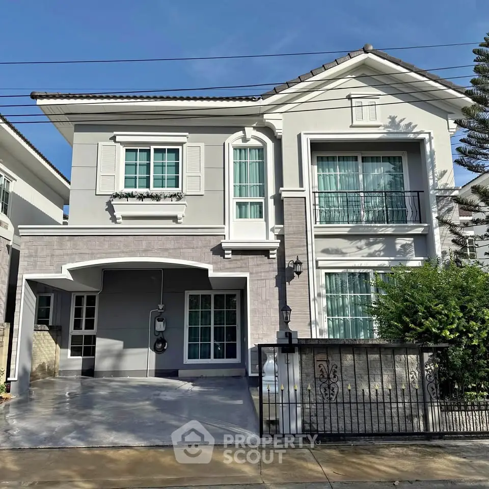 Elegant two-story house with modern facade and spacious driveway in a serene neighborhood.