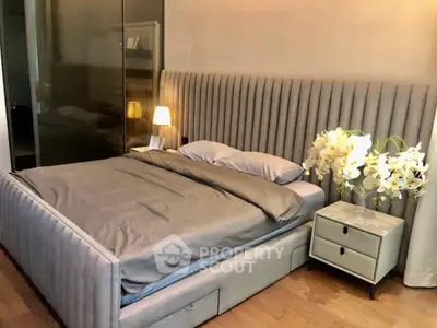 Luxurious modern bedroom with elegant grey upholstered bed and stylish decor