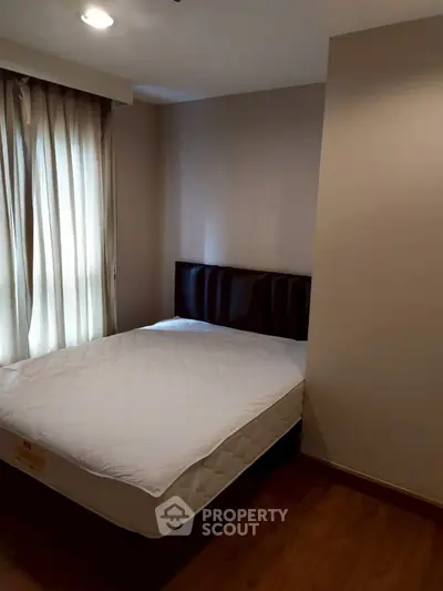 Cozy bedroom with natural light and elegant decor, perfect for relaxation.