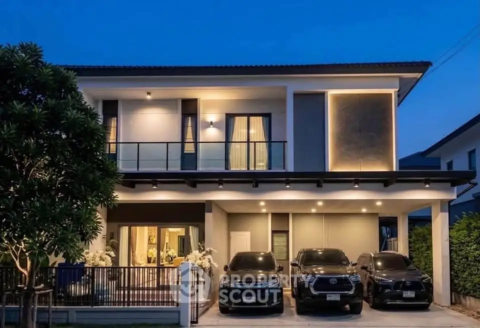 Modern two-story house with sleek design and spacious driveway at dusk.