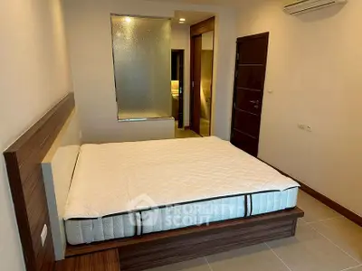 Modern bedroom with stylish bed and air conditioning in a contemporary apartment.