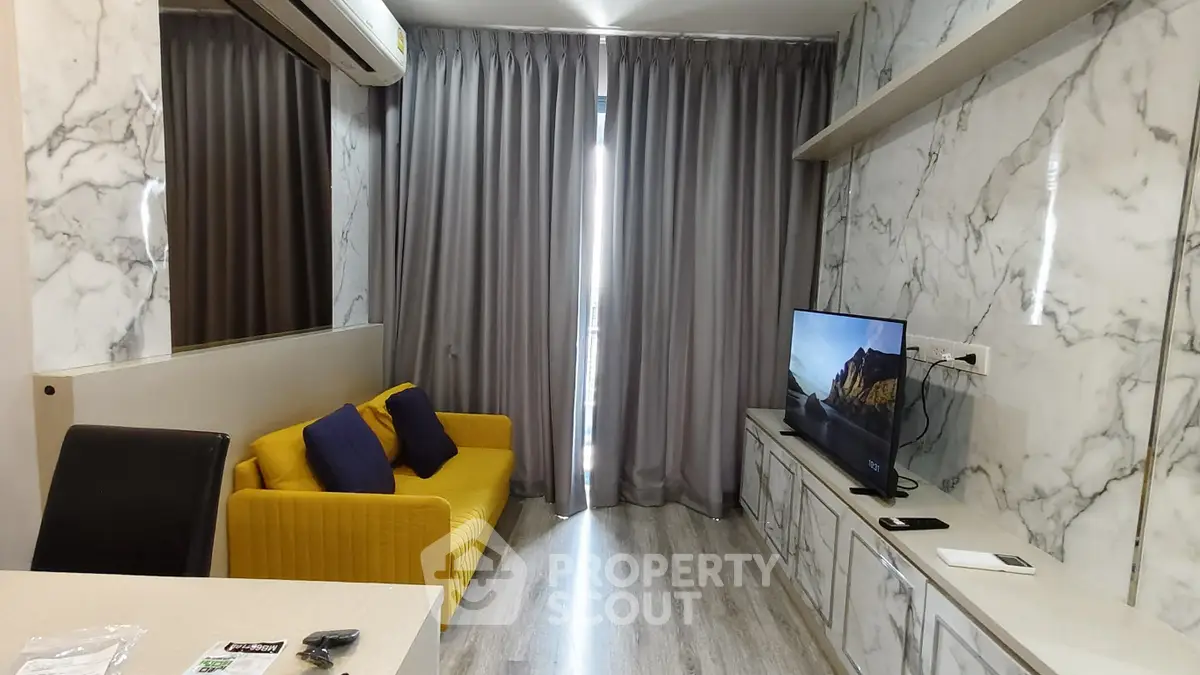 Modern living room with marble walls, yellow sofa, and flat-screen TV for stylish urban living.